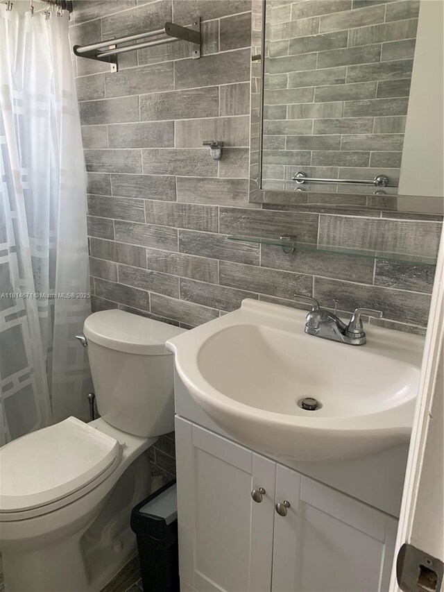 1105 NE 119th St, Biscayne Park, FL 33161 - full bathroom featuring tile walls, vanity, backsplash, and a shower with shower curtain