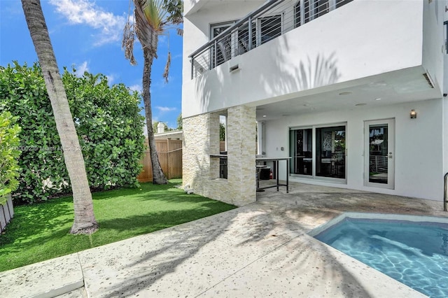 2612 Key Largo Ln, Fort Lauderdale, FL 33312 - rear view of property featuring stucco siding, a patio, stone siding, and exterior kitchen