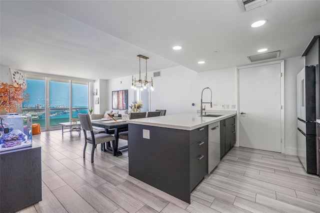 50 Biscayne Blvd Unit 3106, Miami, FL 33132 - kitchen featuring a sink, stainless steel appliances, light countertops, a peninsula, and wood tiled floors