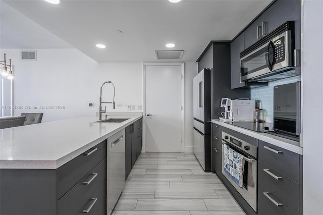 50 Biscayne Blvd Unit 3106, Miami, FL 33132 - kitchen with appliances with stainless steel finishes, a sink, light countertops, a peninsula, and modern cabinets