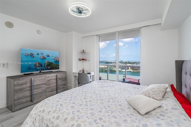 50 Biscayne Blvd Unit 3106, Miami, FL 33132 - bedroom featuring wood finished floors and a wall of windows