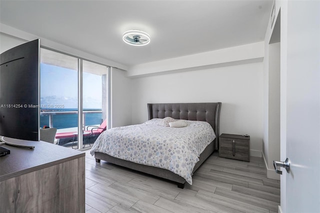 50 Biscayne Blvd Unit 3106, Miami, FL 33132 - bedroom featuring a wall of windows and light wood-type flooring