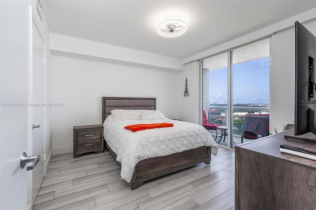 50 Biscayne Blvd Unit 3106, Miami, FL 33132 - bedroom featuring light wood-style flooring and floor to ceiling windows