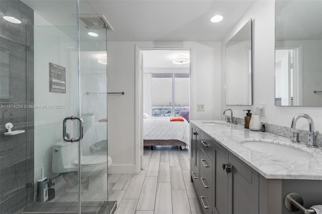 50 Biscayne Blvd Unit 3106, Miami, FL 33132 - ensuite bathroom featuring double vanity, a stall shower, recessed lighting, toilet, and baseboards