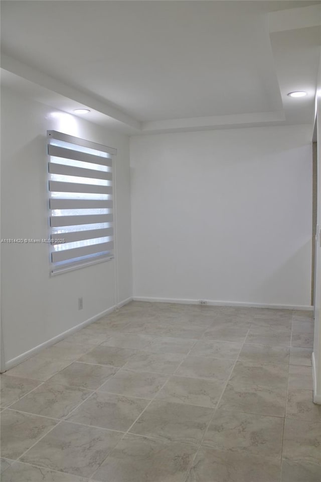 251 SW 132nd Way Unit 306H, Pembroke Pines, FL 33027 - unfurnished room with baseboards and a tray ceiling