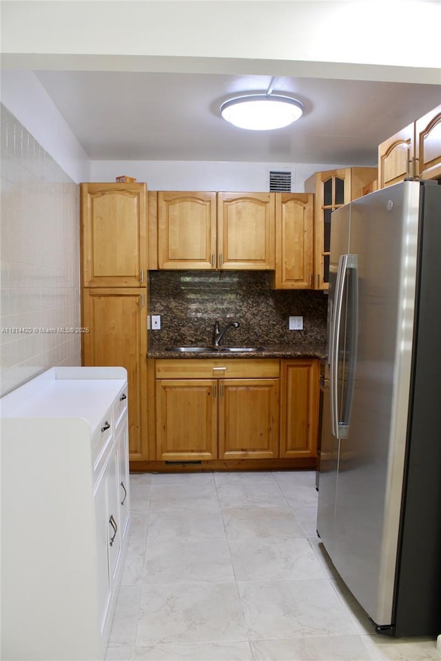 251 SW 132nd Way Unit 306H, Pembroke Pines, FL 33027 - kitchen with freestanding refrigerator, decorative backsplash, and dark stone counters