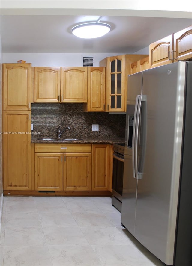 251 SW 132nd Way Unit 306H, Pembroke Pines, FL 33027 - kitchen featuring appliances with stainless steel finishes, glass insert cabinets, dark stone counters, and tasteful backsplash