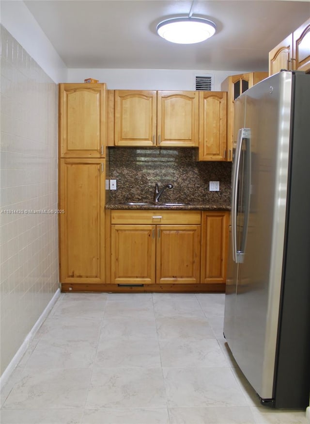 251 SW 132nd Way Unit 306H, Pembroke Pines, FL 33027 - kitchen with freestanding refrigerator, dark stone countertops, and backsplash