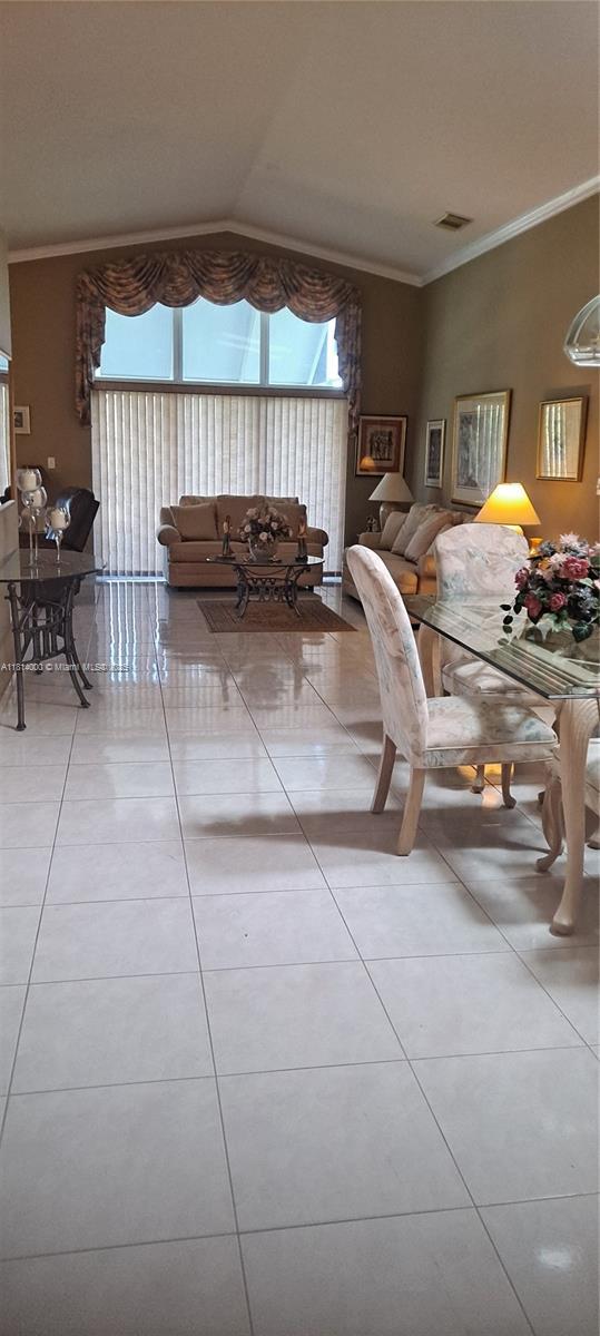 520 NW 166th Ave, Pembroke Pines, FL 33028 - tiled dining room with crown molding and vaulted ceiling