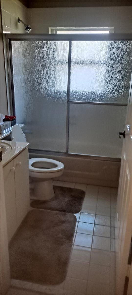 520 NW 166th Ave, Pembroke Pines, FL 33028 - full bath with toilet, vanity, enclosed tub / shower combo, and tile patterned flooring