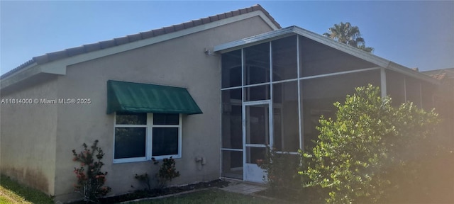 520 NW 166th Ave, Pembroke Pines, FL 33028 - view of home's exterior featuring stucco siding, a tiled roof, and a sunroom