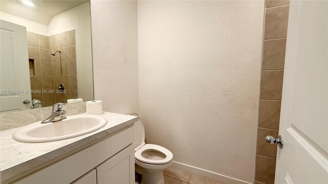 322 NE 1st Dr, Florida City, FL 33034 - full bath with a textured wall, vanity, tile patterned floors, and tiled shower
