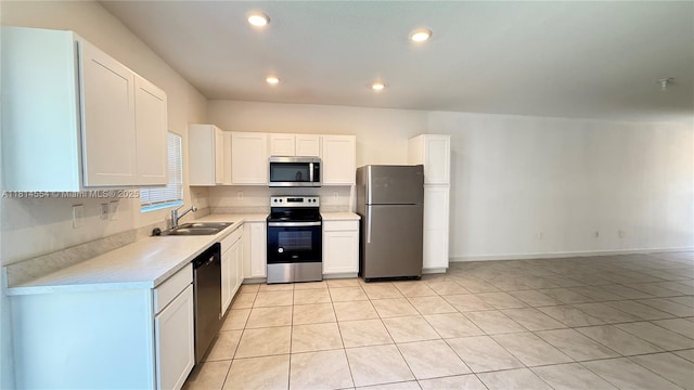 322 NE 1st Dr, Florida City, FL 33034 - kitchen featuring stainless steel appliances, light countertops, light tile patterned flooring, white cabinetry, and recessed lighting