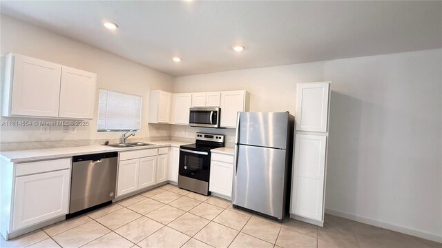 322 NE 1st Dr, Florida City, FL 33034 - kitchen featuring appliances with stainless steel finishes, light countertops, white cabinets, light tile patterned floors, and recessed lighting