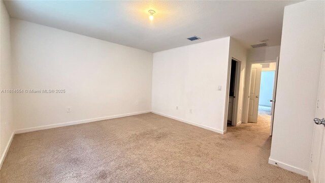 322 NE 1st Dr, Florida City, FL 33034 - empty room featuring light carpet and baseboards