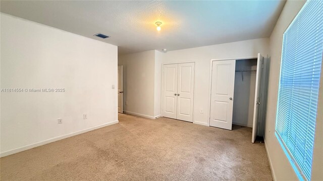 322 NE 1st Dr, Florida City, FL 33034 - unfurnished bedroom with multiple closets and carpet floors