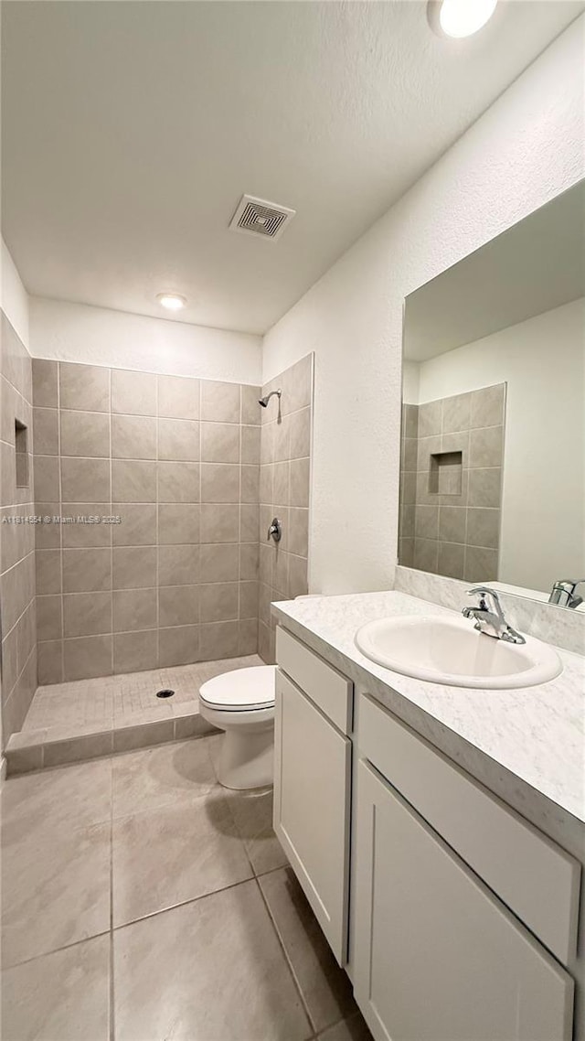 322 NE 1st Dr, Florida City, FL 33034 - bathroom featuring vanity, a tile shower, and tile patterned flooring