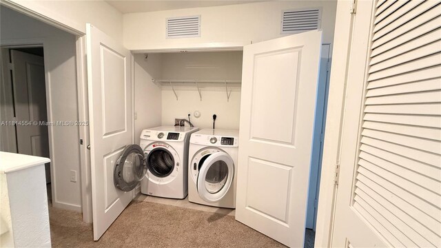 322 NE 1st Dr, Florida City, FL 33034 - washroom with washing machine and dryer and light carpet