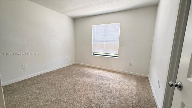 322 NE 1st Dr, Florida City, FL 33034 - carpeted empty room featuring baseboards