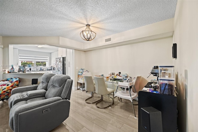 2649 SE 19th Ct Unit 106-D, Homestead, FL 33035 - dining room with a chandelier, a textured ceiling, and light wood-type flooring