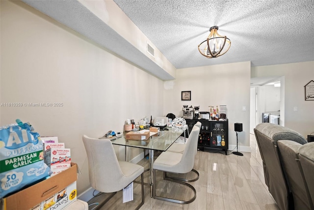 2649 SE 19th Ct Unit 106-D, Homestead, FL 33035 - dining room with a chandelier, a textured ceiling, wood finished floors, and baseboards