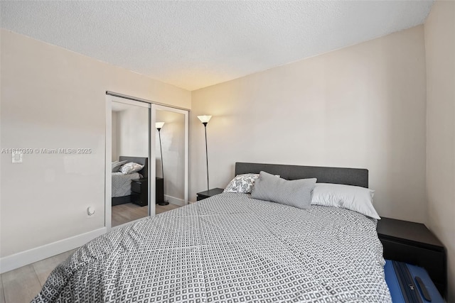2649 SE 19th Ct Unit 106-D, Homestead, FL 33035 - bedroom featuring a closet, baseboards, and a textured ceiling