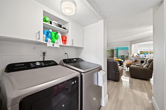2649 SE 19th Ct Unit 106-D, Homestead, FL 33035 - laundry room featuring cabinet space, independent washer and dryer, light wood-style floors, and a textured ceiling