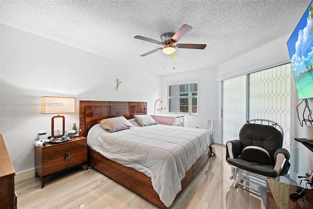 2649 SE 19th Ct Unit 106-D, Homestead, FL 33035 - bedroom with light wood-style flooring, a ceiling fan, a textured ceiling, and a closet