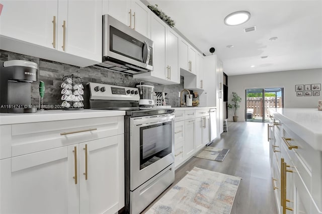 24686 SW 119th Pl, Homestead, FL 33032 - kitchen featuring stainless steel appliances, decorative backsplash, and white cabinetry