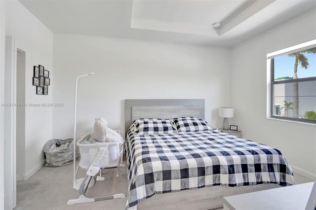 24686 SW 119th Pl, Homestead, FL 33032 - carpeted bedroom featuring baseboards and a tray ceiling