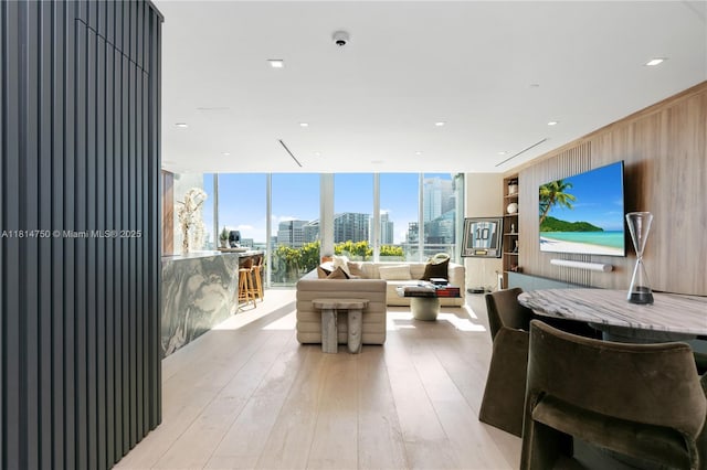 90 SW 3rd St Ph-14, Miami, FL 33130 - living room with light wood finished floors, wooden walls, and a wall of windows