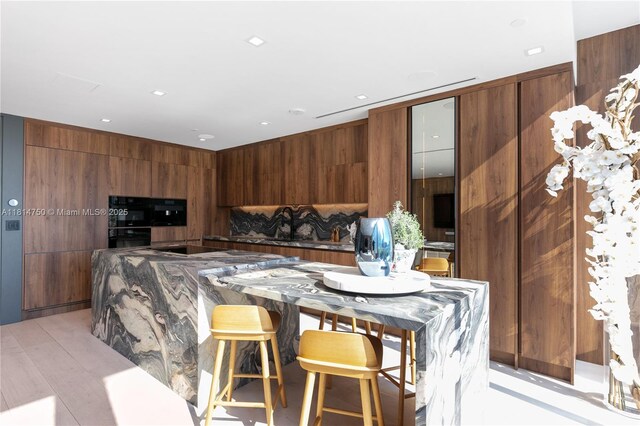 90 SW 3rd St Ph-14, Miami, FL 33130 - kitchen with modern cabinets, brown cabinetry, and black electric cooktop