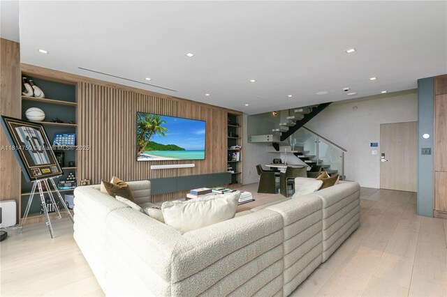 90 SW 3rd St Ph-14, Miami, FL 33130 - living area with stairs, wood finished floors, wood walls, built in features, and recessed lighting