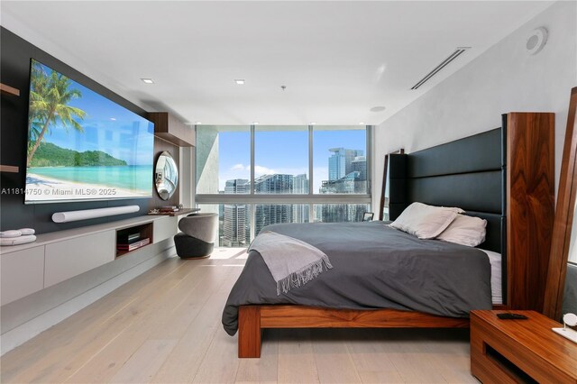 90 SW 3rd St Ph-14, Miami, FL 33130 - bedroom with a wall of windows, a view of city, and wood finished floors
