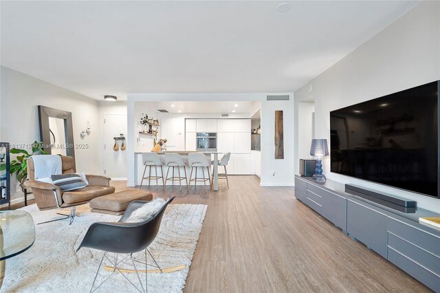 2150 Sans Souci Blvd Unit B311, North Miami, FL 33181 - living room with light wood-type flooring and baseboards