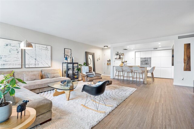 2150 Sans Souci Blvd Unit B311, North Miami, FL 33181 - living area with wood finished floors, baseboards, and recessed lighting