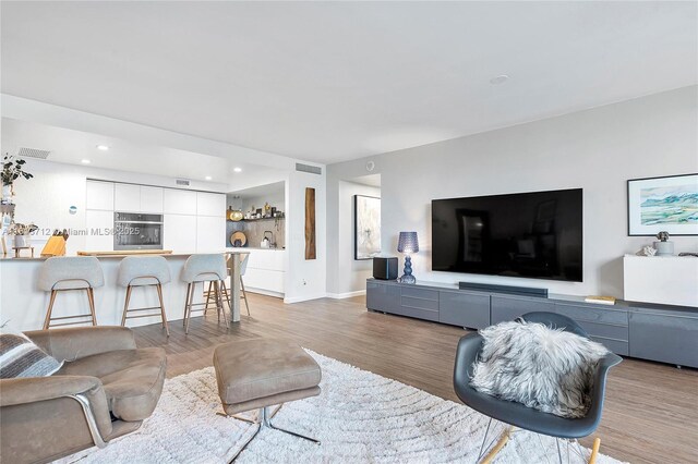 2150 Sans Souci Blvd Unit B311, North Miami, FL 33181 - living room with light wood finished floors, recessed lighting, and baseboards