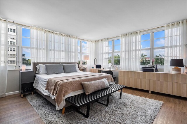 2150 Sans Souci Blvd Unit B311, North Miami, FL 33181 - bedroom featuring wood finished floors and baseboards