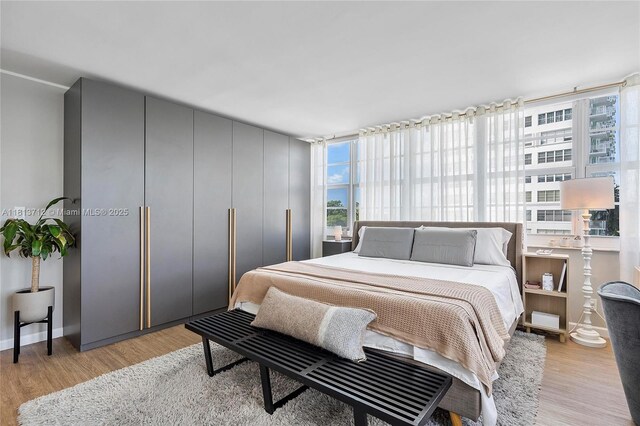 2150 Sans Souci Blvd Unit B311, North Miami, FL 33181 - bedroom featuring light wood-type flooring and baseboards
