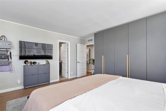 2150 Sans Souci Blvd Unit B311, North Miami, FL 33181 - bedroom featuring wood finished floors, baseboards, and ensuite bath
