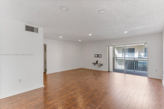 17051 NE 35th Ave Unit 109, North Miami Beach, FL 33160 - unfurnished room with a textured ceiling, wood finished floors, recessed lighting, and baseboards