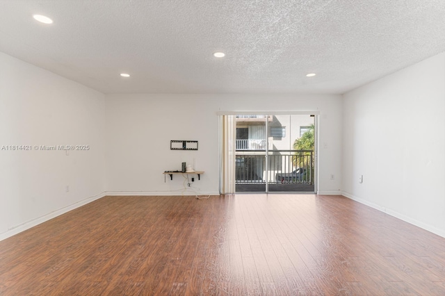 17051 NE 35th Ave Unit 109, North Miami Beach, FL 33160 - empty room with wood finished floors, recessed lighting, a textured ceiling, and baseboards