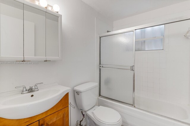 17051 NE 35th Ave Unit 109, North Miami Beach, FL 33160 - bathroom with vanity, toilet, and enclosed tub / shower combo