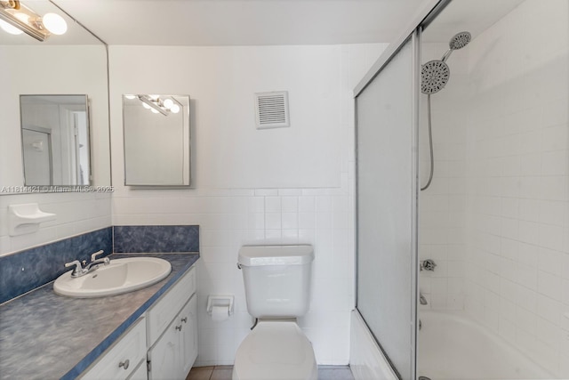 17051 NE 35th Ave Unit 109, North Miami Beach, FL 33160 - full bath featuring vanity, toilet, combined bath / shower with glass door, and tile walls
