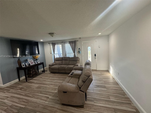 4706 25th Ave SW, Naples, FL 34116 - living room featuring a textured ceiling, wood finished floors, recessed lighting, and baseboards