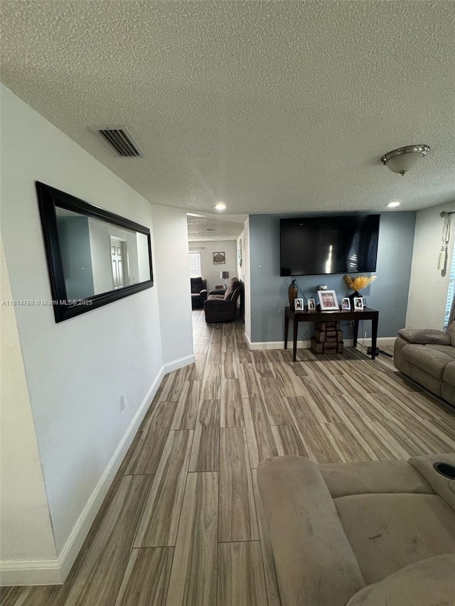 4706 25th Ave SW, Naples, FL 34116 - living room featuring wood finished floors, a textured ceiling, and baseboards