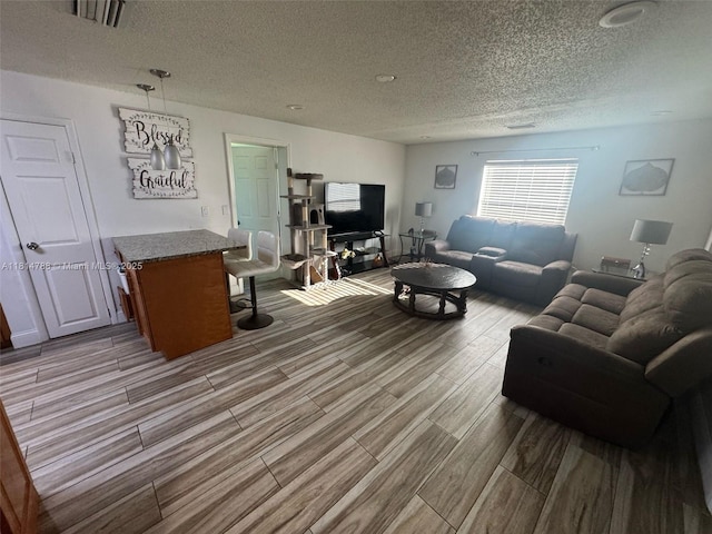 4706 25th Ave SW, Naples, FL 34116 - living area with wood finished floors and a textured ceiling