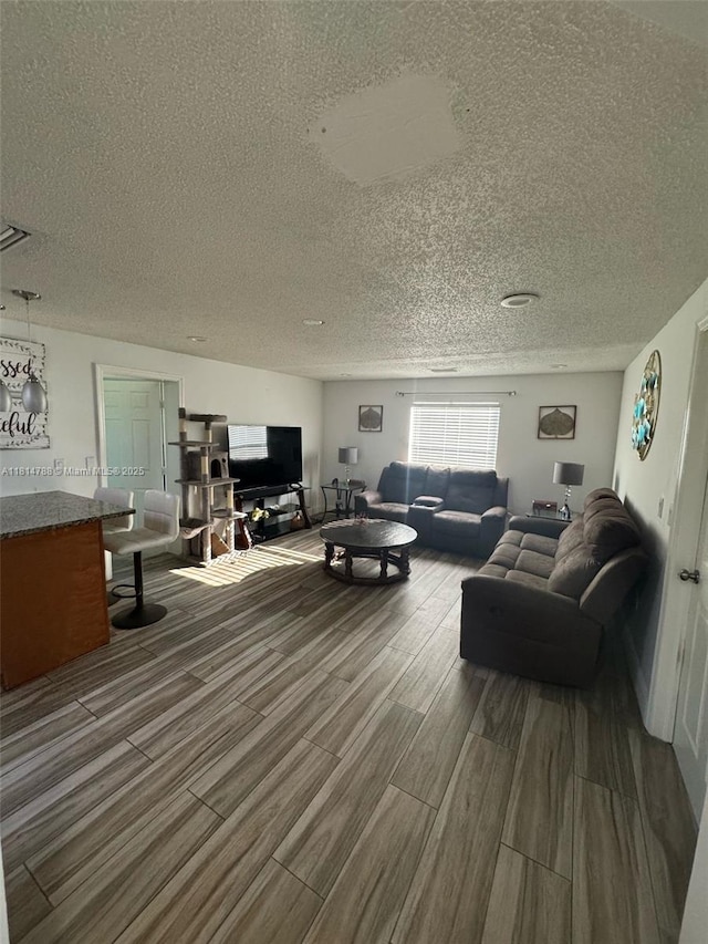 4706 25th Ave SW, Naples, FL 34116 - living area featuring wood finished floors and a textured ceiling