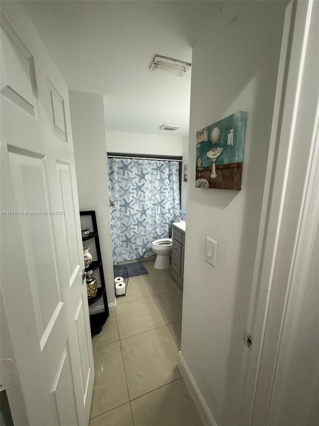 4706 25th Ave SW, Naples, FL 34116 - bathroom with vanity, tile patterned flooring, toilet, curtained shower, and baseboards