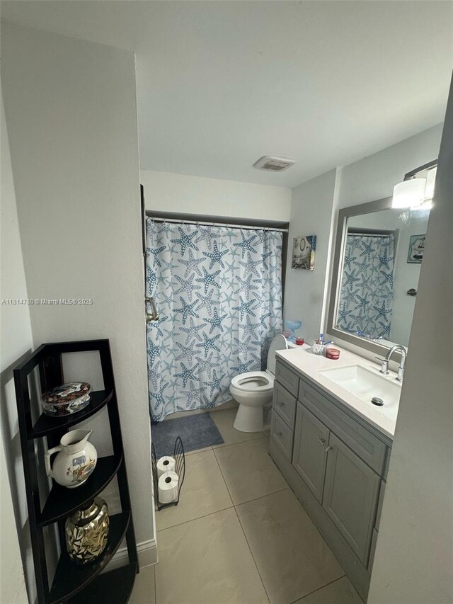 4706 25th Ave SW, Naples, FL 34116 - full bathroom with vanity, toilet, tile patterned floors, and a shower with curtain